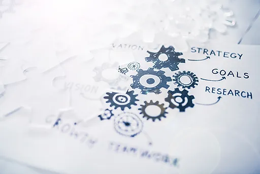 Gears and puzzle pieces lay on a table.