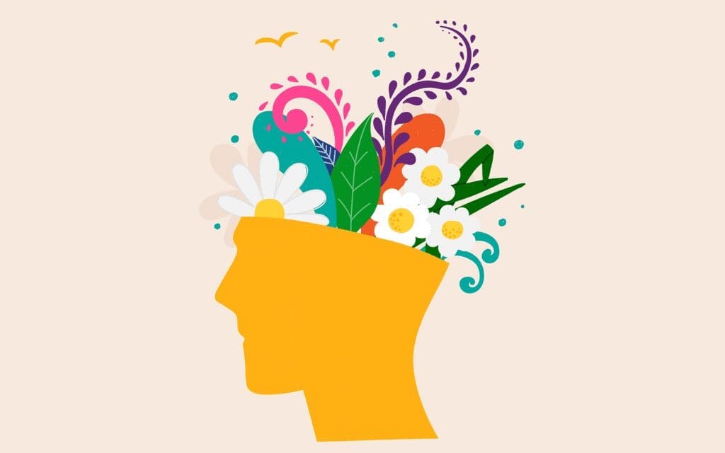 An illustration of a human head with flowers, plants, and wildlife flowing out of the top