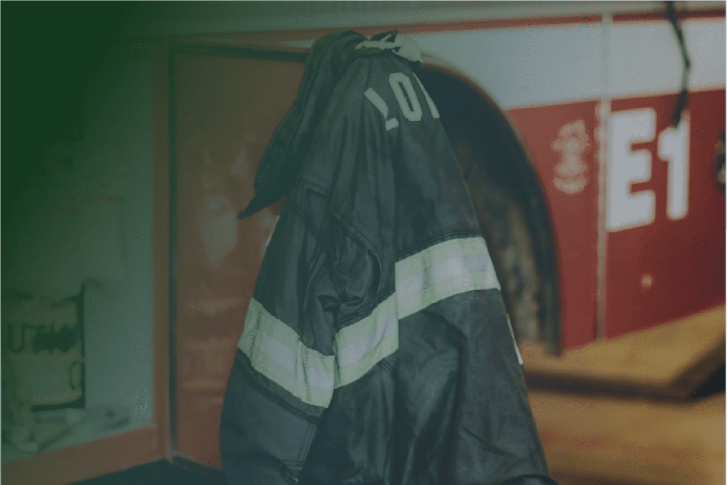 John's firefighter jacket hangs from a fire truck.