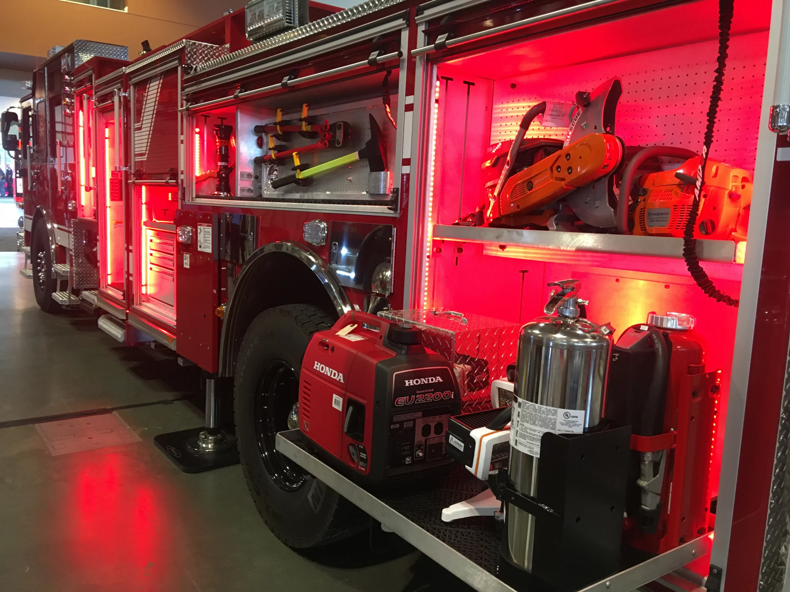 The side of a firetruck at the 2019 Firehouse Expo showcases oxygen tanks, a generator, and more.
